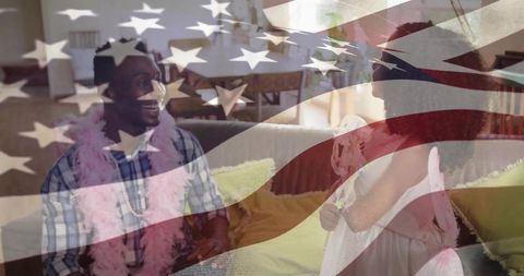 Joyful child in fairy costume with playful father at home