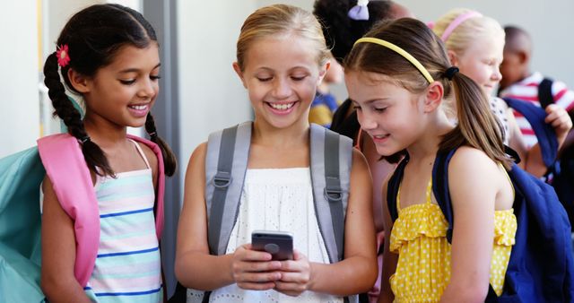 Cheerful Schoolgirls Using Smartphone in Hallway - Download Free Stock Images Pikwizard.com