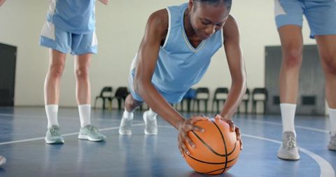 Female Basketball Players Training with Push-Ups on Court