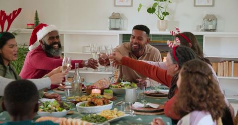 Diverse Family Celebrating Christmas Dinner Toasting Together
