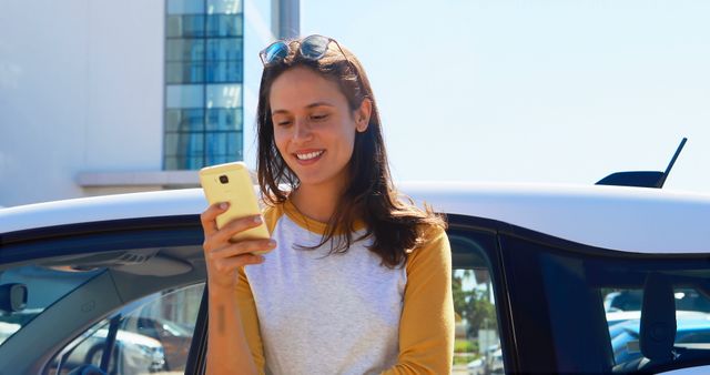 Young Woman Smiling Using Smartphone near Car Outdoors - Download Free Stock Images Pikwizard.com