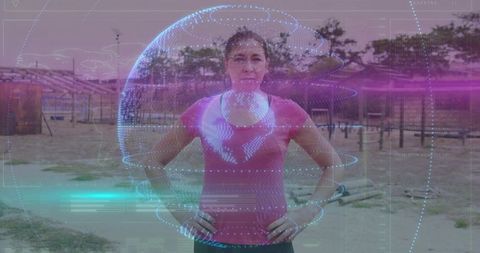 Mid-adult woman standing hands-on-hips with smartwatch and holographic globe