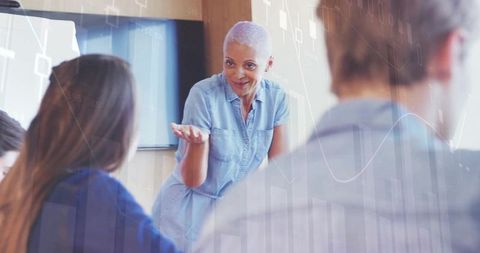 Facilitator leading team discussion in modern corporate setting