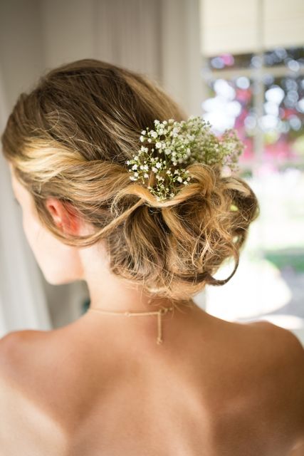 Close up rear view of bride blond hair with flowers
