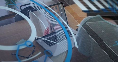 Woman talking on laptop with blue digital overlay reflecting modern remote workspace