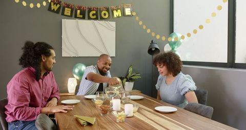 Multiracial friends enjoying housewarming gathering