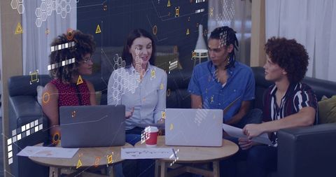 Young Professionals in Collaborative Business Meeting with Technology Overlays