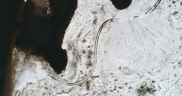 Aerial View of Snow-Covered Landscape with Curvy Path - Download Free Stock Images Pikwizard.com