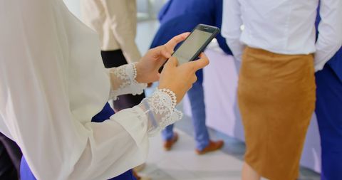 Businesswoman on Smartphone at Business Seminar Queue
