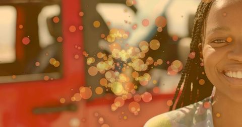 Joyful Woman Smiling Near Red SUV with Sunny Bokeh Effect