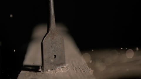 Slow Motion of Drill Bit Creating Sawdust in Wood
