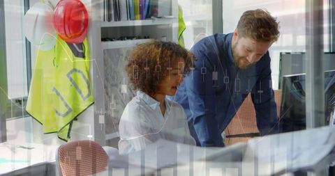 Businessman and Businesswoman Collaborating with Statistics Overlay