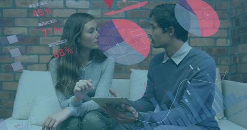Collaborating over tablet with overlaying charts and analytics showing business growth