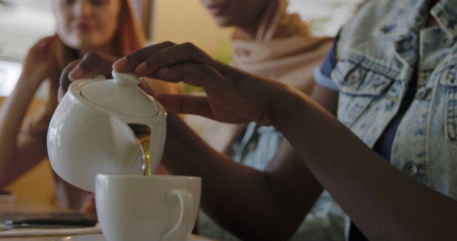 Pouring Tea at Cafe with Friends - Download Free Stock Images Pikwizard.com