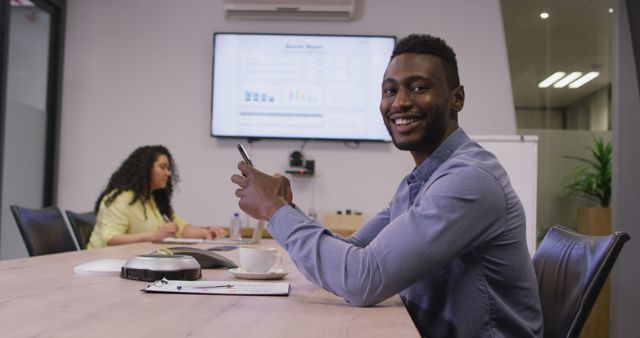 Smiling Businessman Using Smartphone in Office Meeting Room - Download Free Stock Images Pikwizard.com