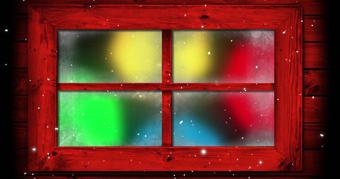 Snow Falling Over Festive Christmas Fairy Lights in Red Window Frame