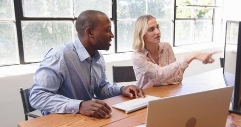 Multiracial Team Collaborating on Project at Modern Office