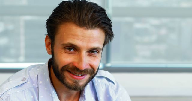 Bearded Man Smiling Confidently in Bright Office - Download Free Stock Images Pikwizard.com