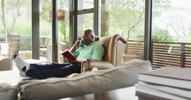 Relaxed Man Reading Book in Cozy Living Room - Download Free Stock Images Pikwizard.com