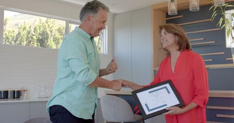Elderly Couple Laughing and Bonding in Bright Kitchen Environment