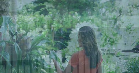 Composite of business graphs with woman in nature