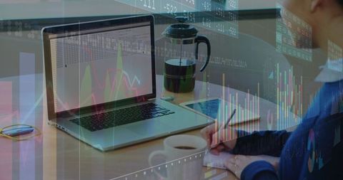 Professional Analysis with Laptop and Coffee in Modern Office