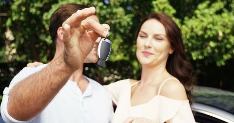 Joyful Couple Celebrating New Car Purchase Outdoors