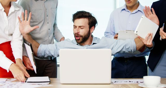 Overwhelmed Businessman Multitasking at Office Desk in Modern Workspace - Download Free Stock Images Pikwizard.com