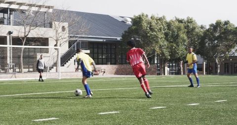 Intense Youth Soccer Game Near Goal with Athlete Action