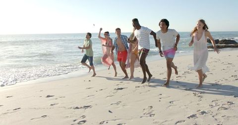 Friends Running Joyfully on Beach Embracing Summer Fun
