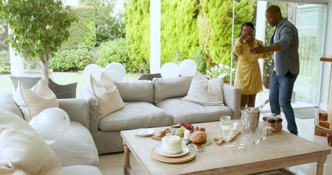 Joyful Embrace of Couple Amidst Romantic Celebration at Home