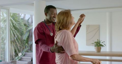 Caregiver Supporting Senior Woman With Balance Therapy