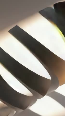 Vertical tilt revealing glowing curved black slats in modern art deco lighting