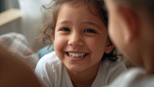 Joyful smiling girl on couch closeup enjoying cozy daylight and candid family moment
