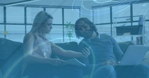 Discussing project on laptop and phone in coworking lounge, teamwork and planning strategy