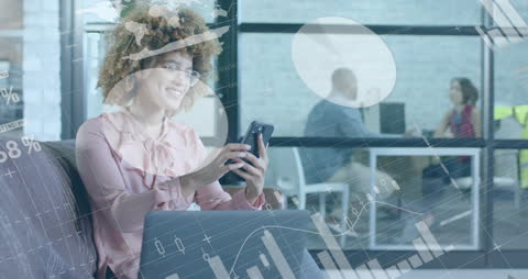 Businesswoman Utilizing Smartphone in Modern Office with Financial Graphics