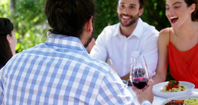 Friends Enjoying Outdoor Meal at a Restaurant - Download Free Stock Images Pikwizard.com