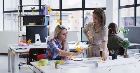 Creative team collaborating over color swatches and layout in bright modern office