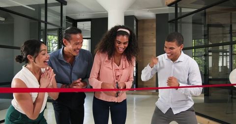 Diverse Colleagues Celebrating Ribbon Cutting Ceremony in Office