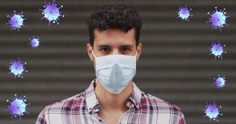 Man Wearing Face Mask with Virus Cells Symbolizing Covid-19 Pandemic