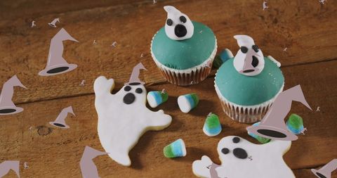Halloween cupcakes with ghost decorations and candy
