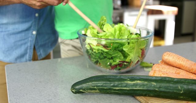 Couple Preparing Fresh Green Salad with Organic Vegetables in Kitchen - Download Free Stock Photos Pikwizard.com
