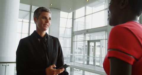 Professional Businesswomen Discussing Work in Modern Office - Download Free Stock Images Pikwizard.com