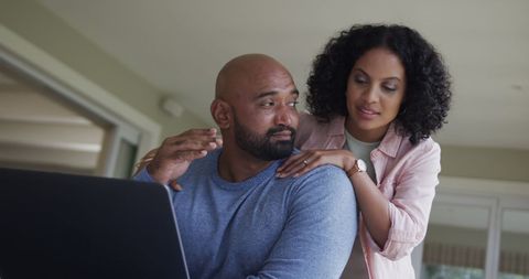 Couple Embracing While Using Laptop at Home