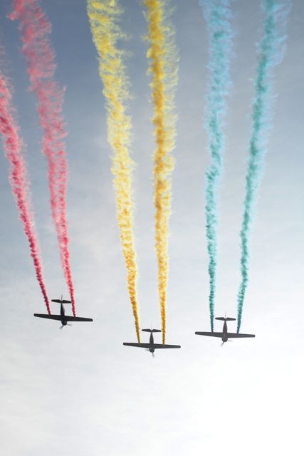 Airplanes Displaying Colorful Smoke Trails in Clear Sky - Download Free Stock Photos Pikwizard.com