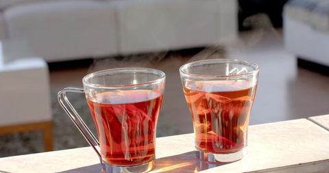 Steaming Amber Tea in Sunlit Glass Cups