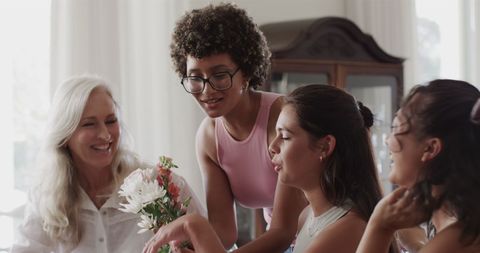 Diverse women enjoying flower arrangement in creative teamwork