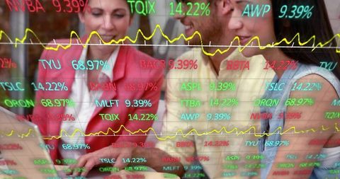 Business team analyzing stock market data on laptop with colorful ticker overlay