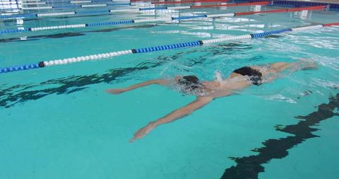 Athlete Performing Front Crawl in Competitive Pool Lane