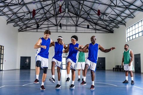 Diverse Male Teammates Celebrating Team Spirit on Basketball Court